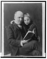 Howard Pyle,1853-1911,looking at book,his daughter Phoebe on his lap,1890-1900 picture
