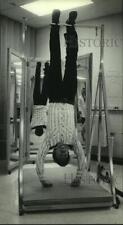 1983 Press Photo Thomas Rand hangs with hanging boots in physical therapy picture
