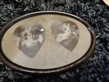 Antique Cupid Awake & Cupid Asleep Heart Matting Oval Tin Frame picture