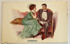 Woman Corners Man. Vintage love and romance postcard early 1900s. picture