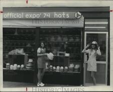 1974 Press Photo Young women trying on official Expo '74 hats. - spb20449 picture
