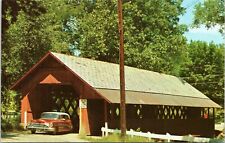 Old car driving through covered bridge in Brattleboro Vermont picture