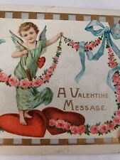 C 1912 A Valentine Message Cherub on Hearts Flowers Bows Embossed Postcard picture
