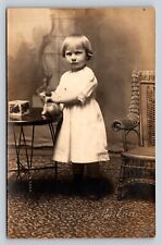 RPPC Little Girl Plays w/ Toy & Glares At Camera ANTIQUE Postcard ARTURA 1910-24 picture
