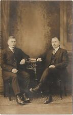 Postcard RPPC 2 Men in Studio in Suits Arms Resting on Table c1910 Real Photo   picture