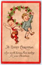 1910's A HAPPY CHRISTMAS DANCING CHILDREN HOLLY WREATH JOY CHRISTMAS POSTCARD picture