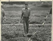1974 Press Photo George Le Barron walks through field on his New York farm picture