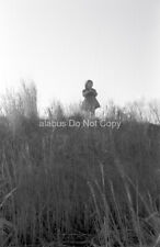 Orig 1960s Found NEGATIVE Little Girl Looking Out Over Hill of Weeds in Winter picture