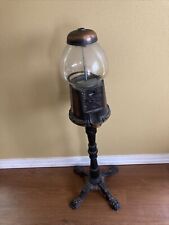 vintage bronze gumball machine on stand picture