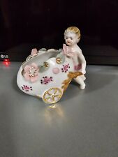 Cupid figurine pushing a cart, vintage picture