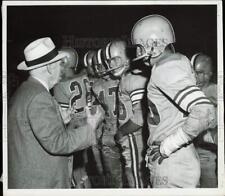 1956 Press Photo An official talks to the football players during game picture