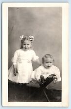 POSTCARD RPPC Two Children in White Gowns Hair Bows Three Legged Stool c1904-20s picture