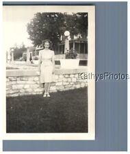 FOUND B&W PHOTO H_7893 PRETTY WOMAN STANDING IN FRONT OF A WALL picture