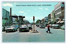 Greetings From Rice Lake Wisconsin WI, Street View Cars Vintage Postcard picture