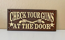 Wall Sign Plaque Says 'Check Your Guns At The Door' Rustic Cast Iron Decor picture