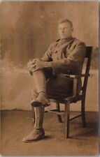 c1920s Military Real Photo RPPC Postcard Young Soldier in Chair, Hands on Knee picture