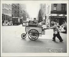 Photo:[[Man pushing hot dog cart with Sabrett stickers on side of cart]] picture
