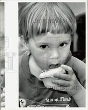 1989 Press Photo Alex Saborwski eats a cupcake in South Miami - lra36012 picture