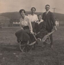 Three Women Sit on Wheelbarrow Man Holds Handles Vintage Found Photo Snapshot picture