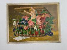Victorian Trade Card Jas G Johnson Cherub in Basket of Flowers picture