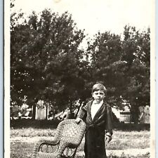 c1910s Handsome Little Boy Outdoors RPPC Wicker Chair Serious Real Photo A129 picture