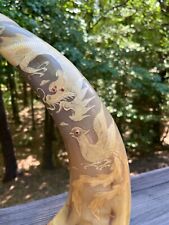 intricately carved water buffalo tusks picture