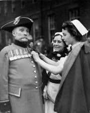 Former Irish Guard having oak leaves pinned uniform by nurse Royal - 1952 Photo picture