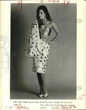1986 Press Photo Exquisite white leather suit with gold bustier for cocktail picture