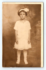 RPPC Young Girl White Dress Hair Bow Stockings Boots Frowning Studio Posed  Z172 picture