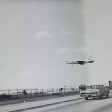 Vintage 1964 Black and White Photo Airplane Flying Over Highway Landing Airport picture