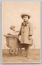 c 1920's RPPC Little Girl Hat Coat w Carriage Pram 2 Baby Dolls Studio Postcard picture