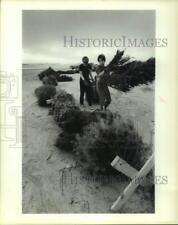 1986 Press Photo Boys lay Christmas trees on Surfside, Texas beach - hcx20594 picture