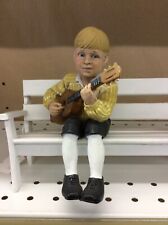 Candy Designs Norway, Boy w/yellow Striped Shirt on White Bench, playing Guitar picture