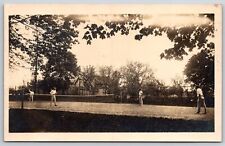 Men's Doubles Tennis Match~Action Shot: Serve~Rough Court~Houses~c1910 RPPC picture