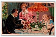 c1910's Merry Christmas Family Dinner Ham Holly Berries Embossed Postcard picture
