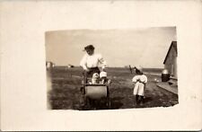 RPPC Strolling the Baby on the Farm Girl in Prairie Bonnet Postcard V10 picture