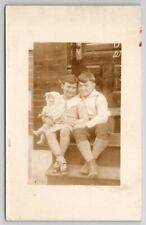 RPPC Cute Kids Hugging Girl With Antique Doll On Porch Steps 1930s Postcard S30 picture