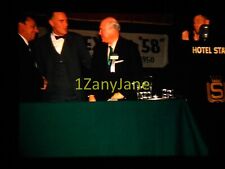 9D15 35MM SLIDE Photo EMCEE AT DAIS, THREE MEN STAND AT TABLE picture