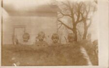 c1920 Four Young Children Help Cleaning Carpet Outside. RPPC. Unposted picture