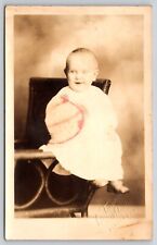 Postcard RPPC Wide Eyed Happy Baby in White Dress Seated Real Photo Children picture