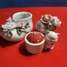 three vintage ceramic figurines: a child's slipper, a pincushion and a swan picture
