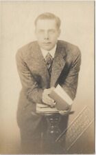 RPPC Man in Studio Leaning and Holding Book c1910 Real Photo Postcard picture