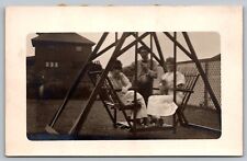 Postcard RPPC Family Sitting in Backyard Swing picture