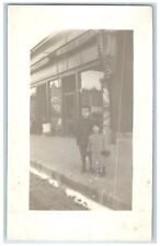 Lansing Iowa IA Postcard RPPC Photo Children In Front Of Barber Shop c1910's picture