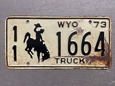VINTAGE 1973 WYOMING LICENSE PLATE BUCKING BRONCO WHITE/BLACK 11-1664 TRUCK 🤠 picture