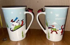 2 Starbucks Coffee Mugs Winter Snow Ice Skaters Dog Sled Airplane 2011 picture