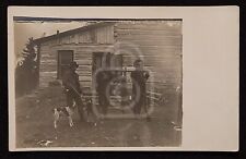 Awesome RPPC of Hunters with a Dead Coyote.  Guns, Dogs, Log Cabin. C 1910's  picture