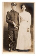RPPC POSTCARD C. 1910s WW1? SOLDIER IN UNIFORM HOLDING SWORD WITH WIFE UNPOSTED picture