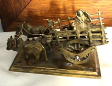 Vintage Brass Ox Cart Pulled by Two Oxen with One Driver and One Passenger picture