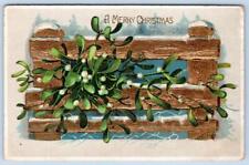 1909 MERRY CHRISTMAS GOLD METALLIC EMBOSSED FENCE GREENERY ANTIQUE POSTCARD picture